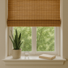 Eco-friendly bamboo blinds in a modern home window with indoor plant and natural daylight, representing sustainable window treatments